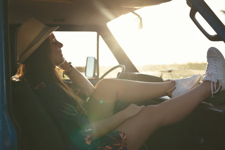 summer holidays, road trip, travel and people concept, young woman resting in minivan carの写真素材