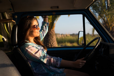 summer holidays, road trip, travel and people concept, young woman resting in minivan carの写真素材