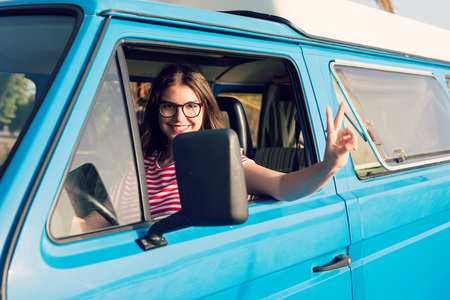summer holidays, road trip, travel and people concept, young woman resting in minivan carの写真素材