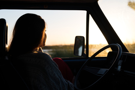 summer holidays, road trip, travel and people concept, young woman resting in minivan carの写真素材