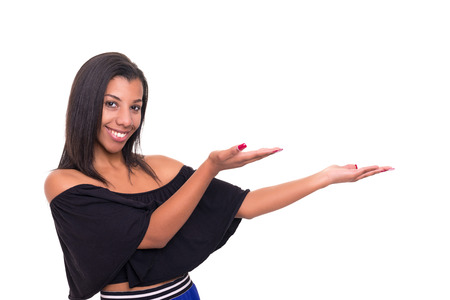 Young beautiful african woman presenting your product, isolated over white backgroundの写真素材