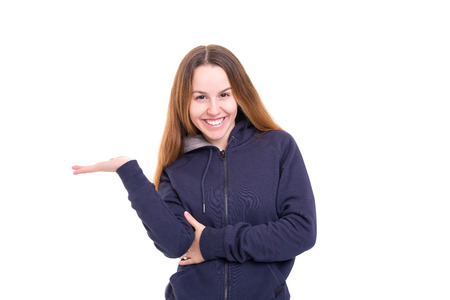 Young beautiful woman presenting your product, isolated over white backgroundの写真素材