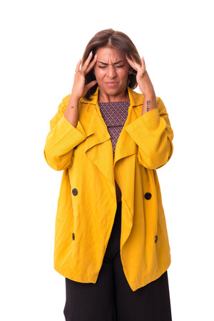 Young woman with an headache, isolated over a white backgroundの写真素材