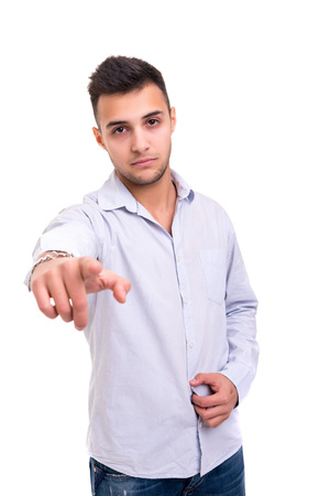 Handsome young man pointing at you, isolated over white backgroundの写真素材