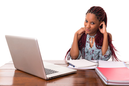 Young african student working with her laptop, isolated over a white backgroundの写真素材