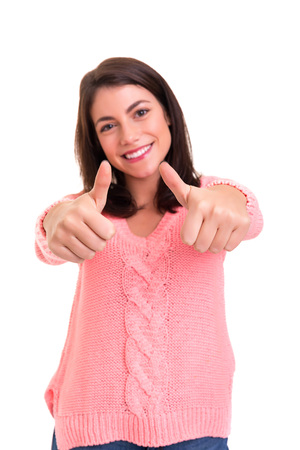 Beautiful young woman signaling ok, isolated over whiteの写真素材