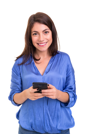 Young beautiful woman at the phone, isolated over a white backgroundの写真素材