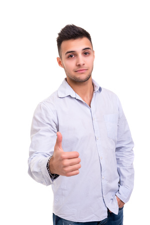 Handsome young man signaling ok, isolated over a white backgroundの写真素材
