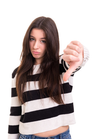 Studio shot of a young woman signaling thumbs downの写真素材