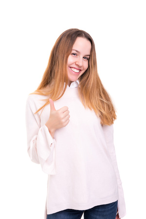 Beautiful young woman signaling ok, isolated over whiteの写真素材