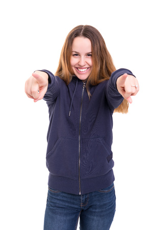 Young beautiful woman pointing at you, isolated over whiteの写真素材