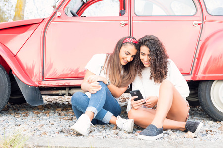 Two friends going on a roadtrip through countrysideの写真素材