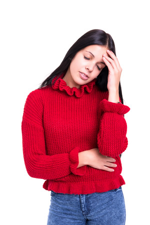 Young woman with a strong headache, isolated over white backgroundの写真素材