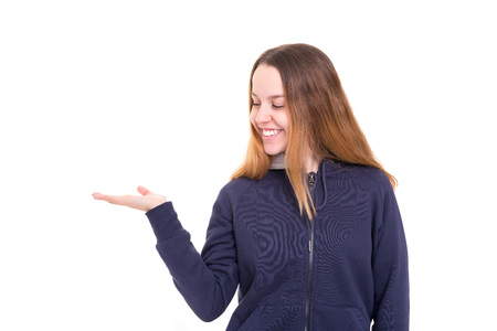 Young beautiful woman presenting your product, isolated over white backgroundの写真素材