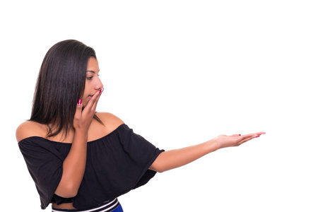 Young beautiful african woman presenting your product, isolated over white backgroundの写真素材