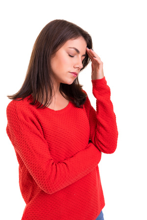 Young woman with a strong headache, isolated over white backgroundの写真素材