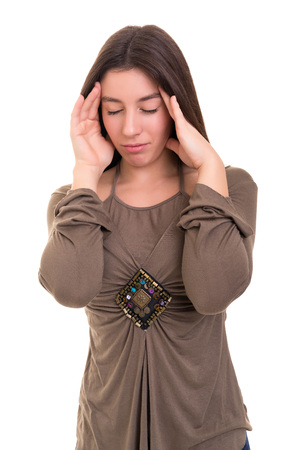 Young woman with a strong headache, isolated over white backgroundの写真素材