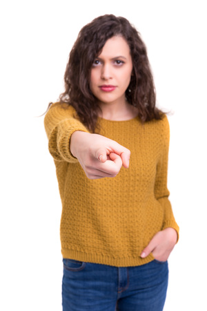 Young beautiful woman pointing at you, isolated over whiteの写真素材