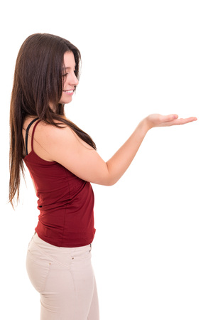Young beautiful woman presenting your product, isolated over white backgroundの写真素材