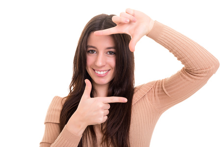 Young woman making framing key gesture - isolated over whiteの写真素材