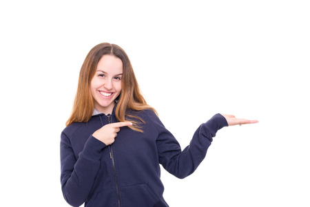 Young beautiful woman presenting your product, isolated over white backgroundの写真素材