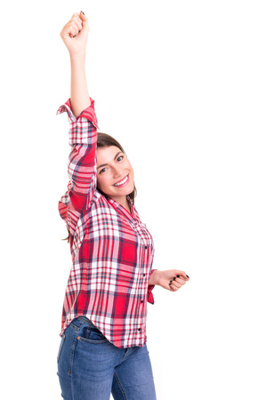 Studio shot: Happy woman with raised armsの写真素材