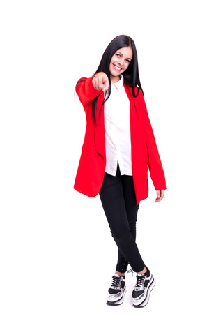 Young beautiful woman pointing at you, isolated over whiteの写真素材