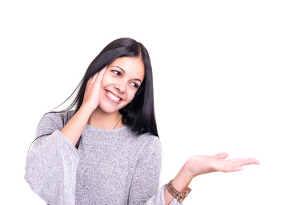 Young beautiful woman presenting your product, isolated over white backgroundの写真素材