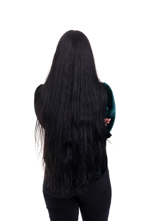 Woman posing with her back faced to camera, isolated over copy space backgroundの写真素材