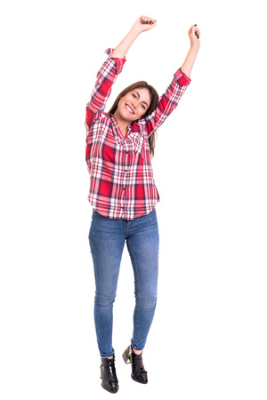 Studio shot: Happy woman with raised armsの写真素材