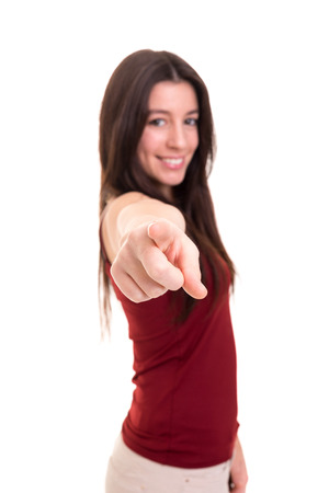 Young beautiful woman pointing at you, isolated over whiteの写真素材