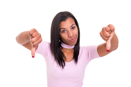 Studio shot of a young woman signaling thumbs downの写真素材