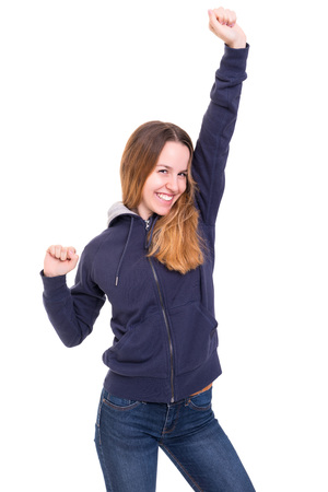 Studio shot: Happy woman with raised armsの写真素材
