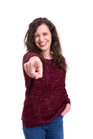 Young beautiful woman pointing at you, isolated over whiteの写真素材
