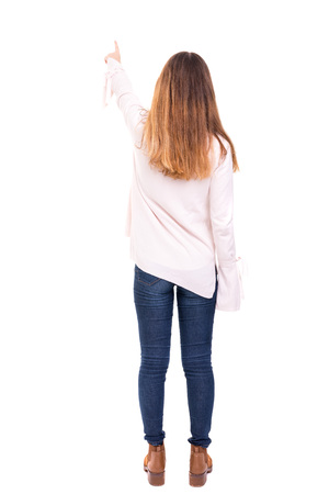 Woman posing with her back faced to camera, isolated over copy space backgroundの写真素材