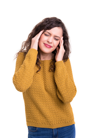 Young woman with a strong headache, isolated over white backgroundの写真素材