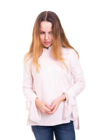 Studio shot of a sad woman, isolated over whiteの写真素材