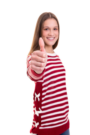 Beautiful young woman signaling ok, isolated over whiteの写真素材