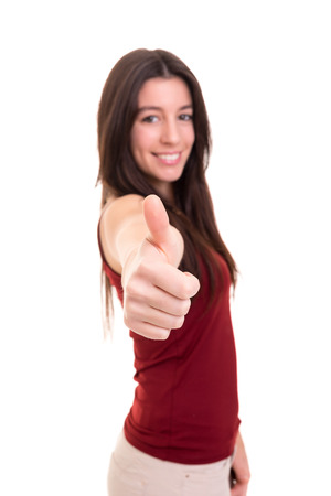 Beautiful young woman signaling ok, isolated over whiteの写真素材