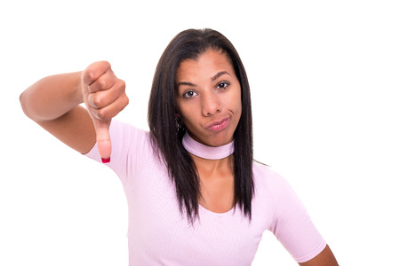 Studio shot of a young woman signaling thumbs downの写真素材