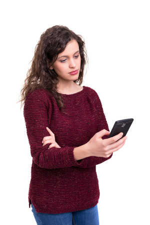 Young beautiful woman at the phone, isolated over a white backgroundの写真素材