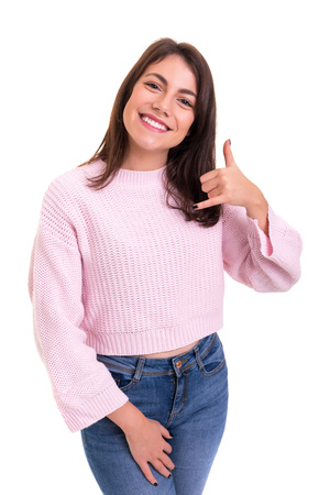 Happy young student making "call me" sign with handの写真素材