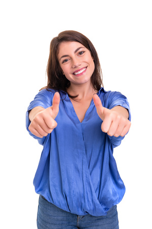 Beautiful young woman signaling ok, isolated over whiteの写真素材