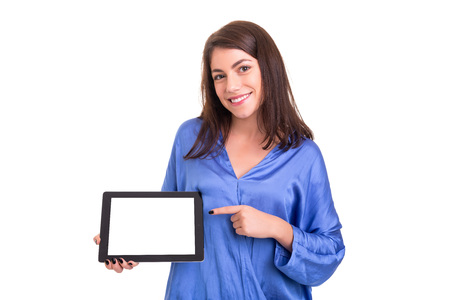 Happy young woman presenting your product in a tablet computerの写真素材