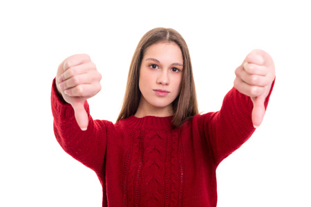 Studio shot of a young woman signaling thumbs downの写真素材