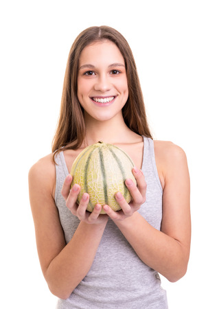 Young woman holding a fresh watermelon, isolated over white backgroundの写真素材