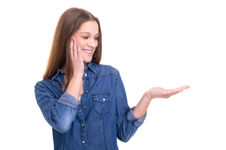 Young beautiful woman presenting your product, isolated over white backgroundの写真素材