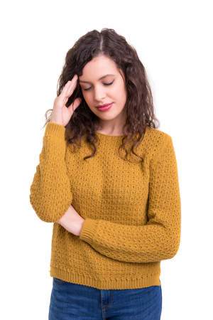 Young woman with a strong headache, isolated over white backgroundの写真素材
