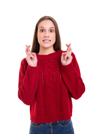 Woman with crossed fingers, isolated over a white backgroundの写真素材