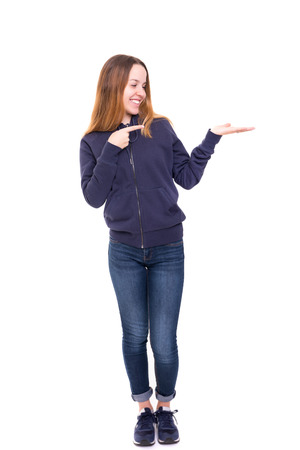 Young beautiful woman presenting your product, isolated over white backgroundの写真素材